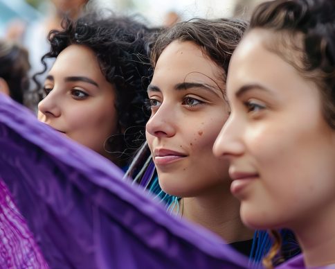 Stock photo of a group of women standing next to a purple flag, vivid facial expressions, hispanicore, selective focus, adonna khare, rubÃ©n maya, organic movement, --ar 3:2 --style raw --stylize 50