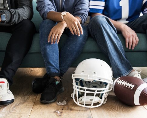 Friends cheering sport league together