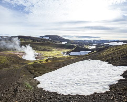 A beautiful scenery of  pools of boiling water and snow in the mountains on the 54 km trek from Landmannalaugar