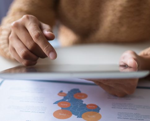 Close-up of lady using tablet while examining data. Unrecognizable woman working with online information while preparing annual report. Statistics concept NGHI