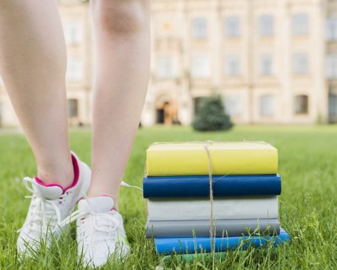 close-up-teenage-girl-walking-near-books