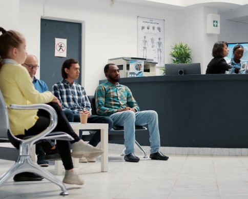 Diverse group of people waiting in hospital reception lobby to attend medical appointment with general practitioner. Patients in waiting room lobby sitting at healthcare clinic. Tripod shot. SSUCv3H4sIAAAAAAAAA1VTy67bNhD9F61NlG+K/oCimwDdB1kMyeE1EUk0JCqJYfjfO5Tc3FYLgTNzeIZnHs+hpOE6WGuyFJkzZeTINCpkXnrLZHTIlUVD1nAZEjQcrkIpLrTjXHkrR07fZQiwlThcn0OZpn1rK7RSl+FKkRWXhOtxxFRaXQtMZL0uw9ag7Rtu/dp221vDdWs1fj+wkGrATzOtCPPWyoyH+YDHXOJaD0NIteYThfe6lXa/1Va3wxNhOUgO1+G51yWZM1anuq+h/joTTjA/TkT51eA4zbXLwAlnXNpJiA/E+R3c/psplI//ZXr15A0/SPAp8V2ir8/up5r/hTC1W4QV//hClYlUFqrJHij0pWwRpwkWrPs2vC7/Xvkb633C37A/YS5TZ/9E/I4Nr2+k6QOXSKKer1dvxIRwlPvrkKSV3ntkyQjLtBacAYJmwmgeswzeOkdUEZ3wyTnmovZMi+TZqJNgIodRBlA880ww50YenApMBBOZ5piZ18YzFcG4mAVoiB0WRsUNjZZFh0wHGJm3KrEkk0tK46hyZ0NuUBoZmE060NvAszAKzZyzoxMZrLQdNnqVjY6WBUia3pYNA/ozKaTzLgTrdJcggvc8J0upTGbaESUoCSQ36qQgEaMmmMk6WKETi4aItAkjg5F+CInmP3ofTYeN3HrpZGTSRJJgA7El5CyGIESSJqO3XcJoOAYpKOg5SSDNIJRnJgnye0xBhZ40EUhS7QXtHtNROxYQJfMxGxOdTza5gdr4/SetxtyHiNpY262vEzW87ktbH2fTp1rvEGg2rhmmDS/DDbaNAOntoIv3tcSyfJwskZa0zud5qa1PxTE7fYJLeqc6F/RWyNvzPIf9PlXSm97hPcyFtvZtrvij4M9P9Ov1+ge1pmBvXgQAAA==