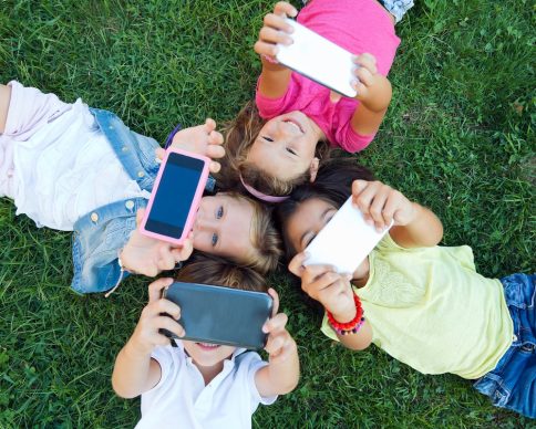 Portrait of group of childrens taking a selfie in the park.