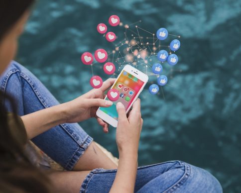 high-angle-woman-holding-smartphone