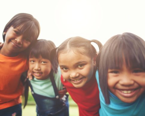 Close up of girl child friends in a park smiling to camera