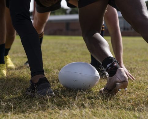 men-playing-rugby-field