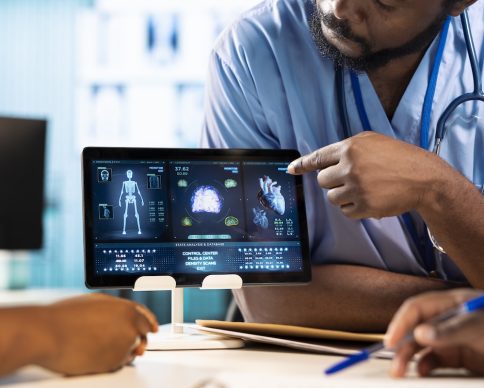 Team of young nurses learning the practice from a doctor expert in the cabinet, emphasizing health care management and diagnostics in a facility. African american residents examine x rays. SSUCv3H4sIAAAAAAAAA41Uy27jOBD8FUPnEOCbVG7zD3sbzIFPm4gkChK1iWH436dJKY6NvWwOgVzsLlZXN/vWJd+9d9gyIgwRKPJeIt57h/reeUSidYxLRqQU3VvnTQndO2FME800VUITjuHvrbNmTa57v3VpGLa1LKakPHXvcLKEyYelfQafSl6SGdova4q7TGYExo4STOZLd3/r1mLKtoa1coV1hkgAHdx7hswdPu76fas4JIOwdbP14/72P7E/b505h8ldge9+ryKHYNqtvzuuWRRBGyQN1ojHaFBvo0OEcBqF1txqD1Tc+j4yKhDlyiMOcUgbyCIy0p5ELKyyEMa4wzEwjqTyDHEdFeojhX+caxwCNz5gCDOs7zE2GklucW0AR5oQhYzWPWGRaaZqmAxaYWMt8gZkcewJsjZKZEPkThFPne87KO7js4RlbG79iktyZjqB0e2jligJZbLGjdASZ4YTuB7jfiIkqyf/BDM2AFMtKuCMTVMoFVNY8Zbus4OGfueJJ8Y9VVD2E3bKMSYX2kmv+0YwX67Qy/St6uBweVq3oRwzBPcRsmuIYTRDY+ilUK1S6GJYoIJ5Ma6kmhEegtRD0I7IvskJX3NYWiGMC8Yob+iTOixJ456XHMO6AudREBGMN85dMIgQpP6+5m06twhFha7ItC3HOEGSxhWyg3EfDaFEsZ3mUYxoIe4S3Mc2v9R8CWYol5MzS3gxdZ0DGDektezXYE6bpQYEQzunHdYKim6KxgzPcPeZUt0oonFpSOW652PZ4la3bLblEqblLn0Ja/LhoCQwqWLvXvN8N01xzZs3Zp5zmsoI4S91AAf09NBKReuNT+Y85RU41pdYWCITGL/bx3BrRlmCebA+XIBnu0zpMB880E+06ZUUmgZv/sFABGkMJcAWykM+HzYIQiv8dVrM9VCrcIM+MyQf/fr2xeURQP8YVYkZVj9tq107pcnXlXjwc3XM+DhvZZ9VgiXtn5udYP4XM+3OwhpQnD6/1vBlxjT993lc8jqncsyqEHUeYLflcqnXwBaEKW0yOqI4LJMh59nYOoLRDGuAfJgdiPEHcK8dhtdZ3b3VLQxV5HH/nnKp4912asnuI/l1P9j39wVGMNerbt02DxmWnD+ONzumUr5/LuHfFD5/ou/3+19ScM3qkgYAAA==