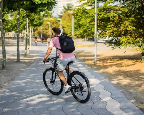 Young sports man on a bicycle in a European city. Sports in urban environments.